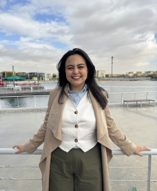 Rahma Daigham, digital marketer and life coach, smiling while sitting and looking confidently at the camera.